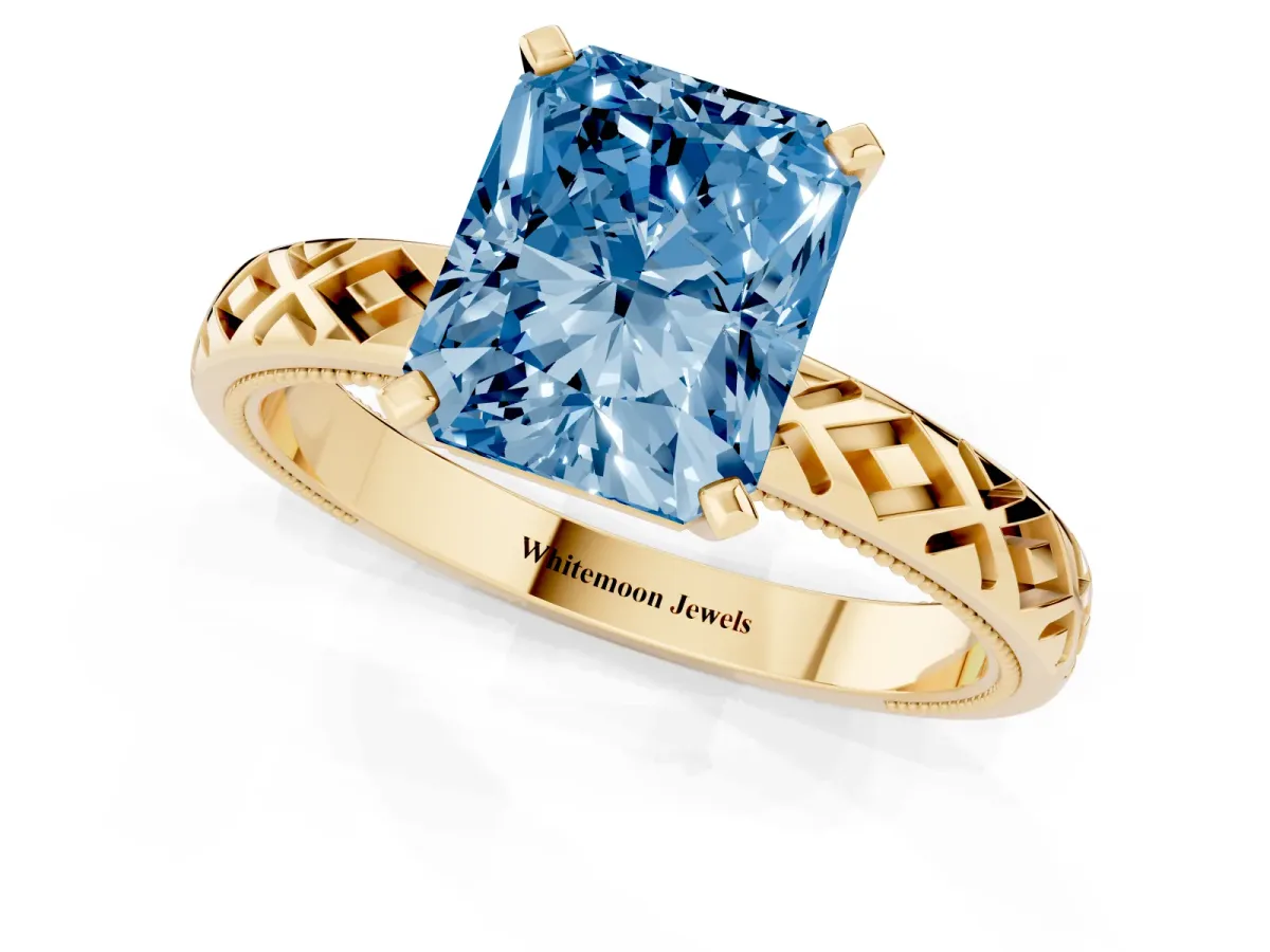 Fancy Blue Radiant Cut Solitaire Diamond Ring with Milgrain and Black Enamel X Pattern Band Yellow gold