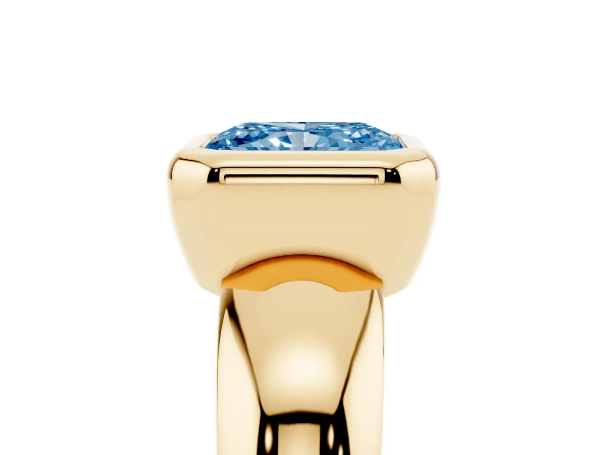 Fancy Blue Bezel Set Radiant Cut Solitaire Ring with Wide Band Yellow gold
