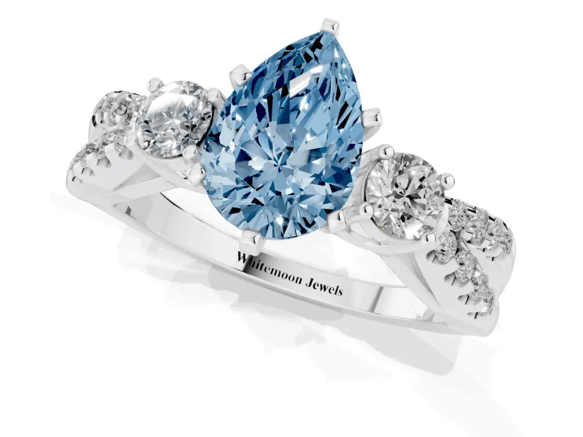 Fancy Blue Pear Cut Diamond Three-Stone Ring with Pavé Split Shank and Four-Prong Setting Silver