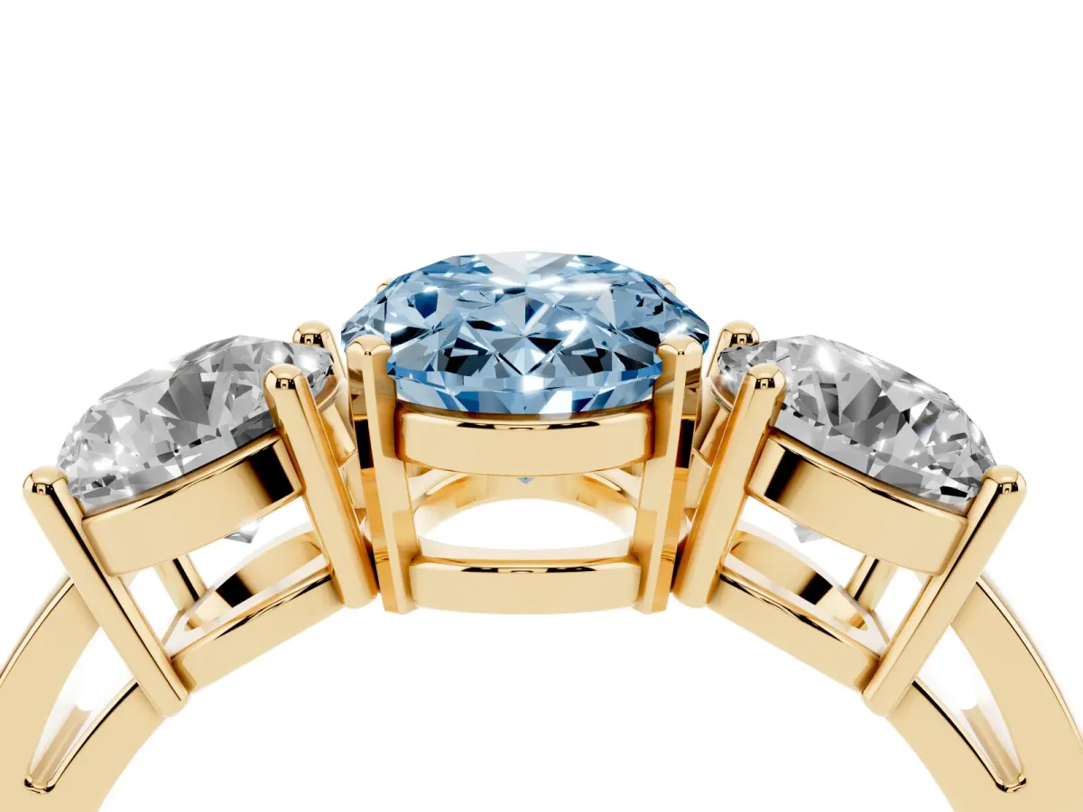 Fancy Blue Three-Stone Oval Cut Diamond Ring with Round Side Stones, Classic Band, and Four-Prong Setting Yellow gold