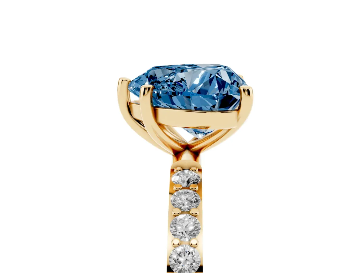 Fancy Blue Heart Cut Diamond Solitaire Ring with Round Pavé Shoulders and Prong Setting Yellow gold