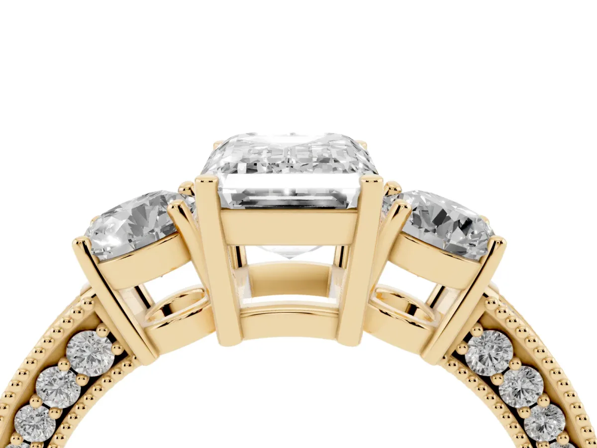 Emerald Cut Three-Stone Diamond Ring with Pavé Band and Four-Prong Setting Yellow gold