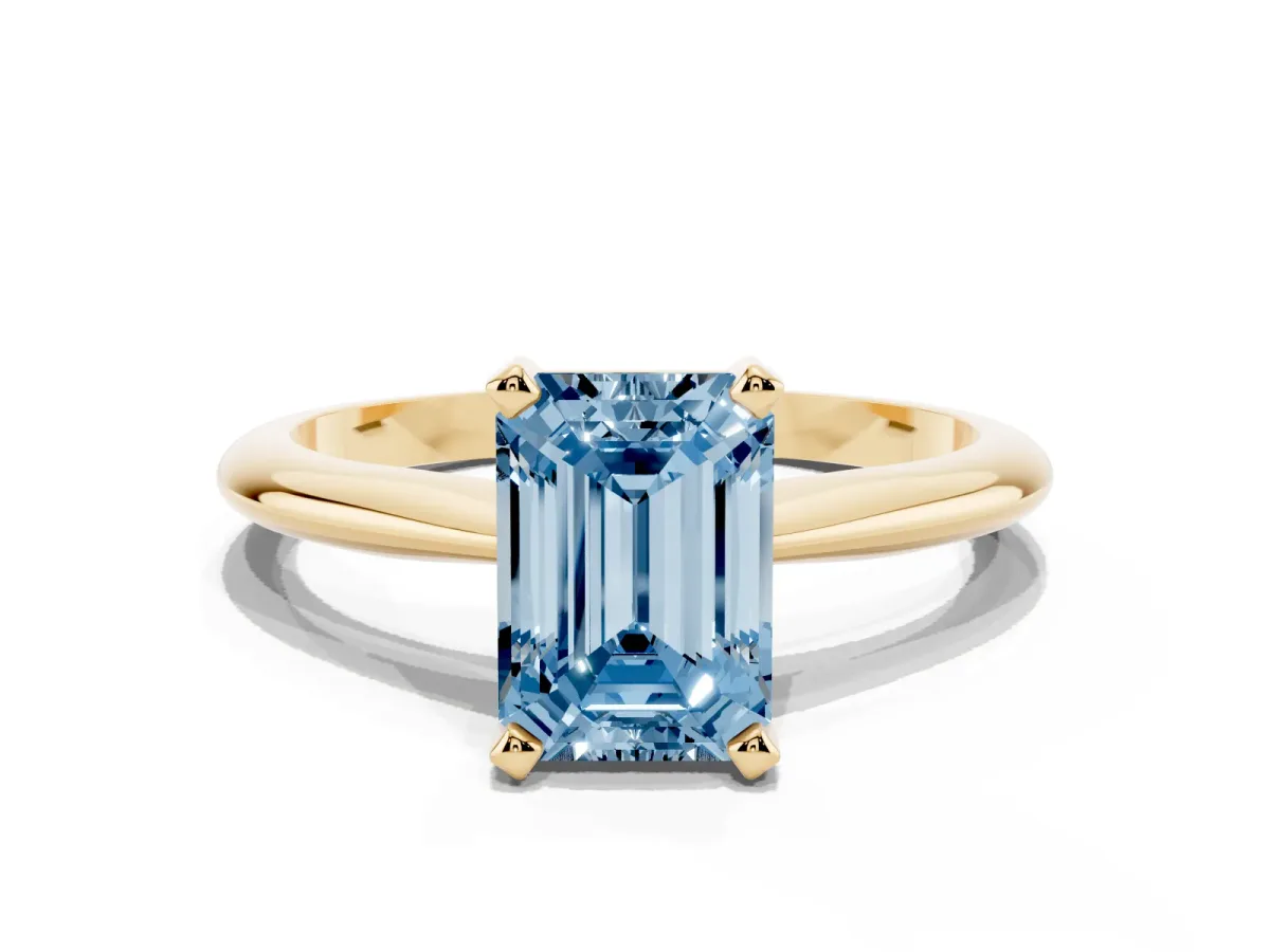 Fancy Blue Emerald Cut Cut Solitaire Ring with Four-Prong Setting on a Classic Band Yellow gold