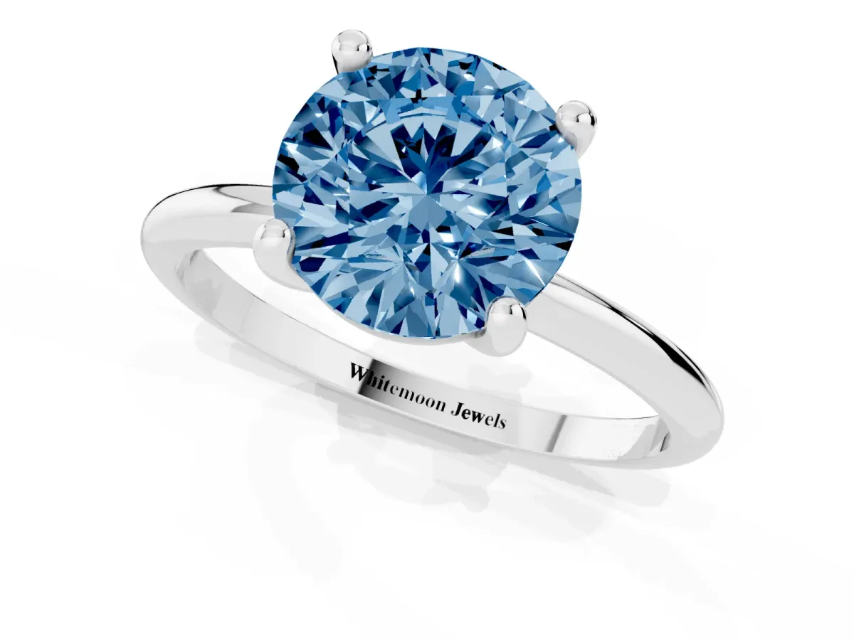 Fancy Blue Round Cut Solitaire Diamond Ring with 4-Prong Setting on a Classic Band Silver