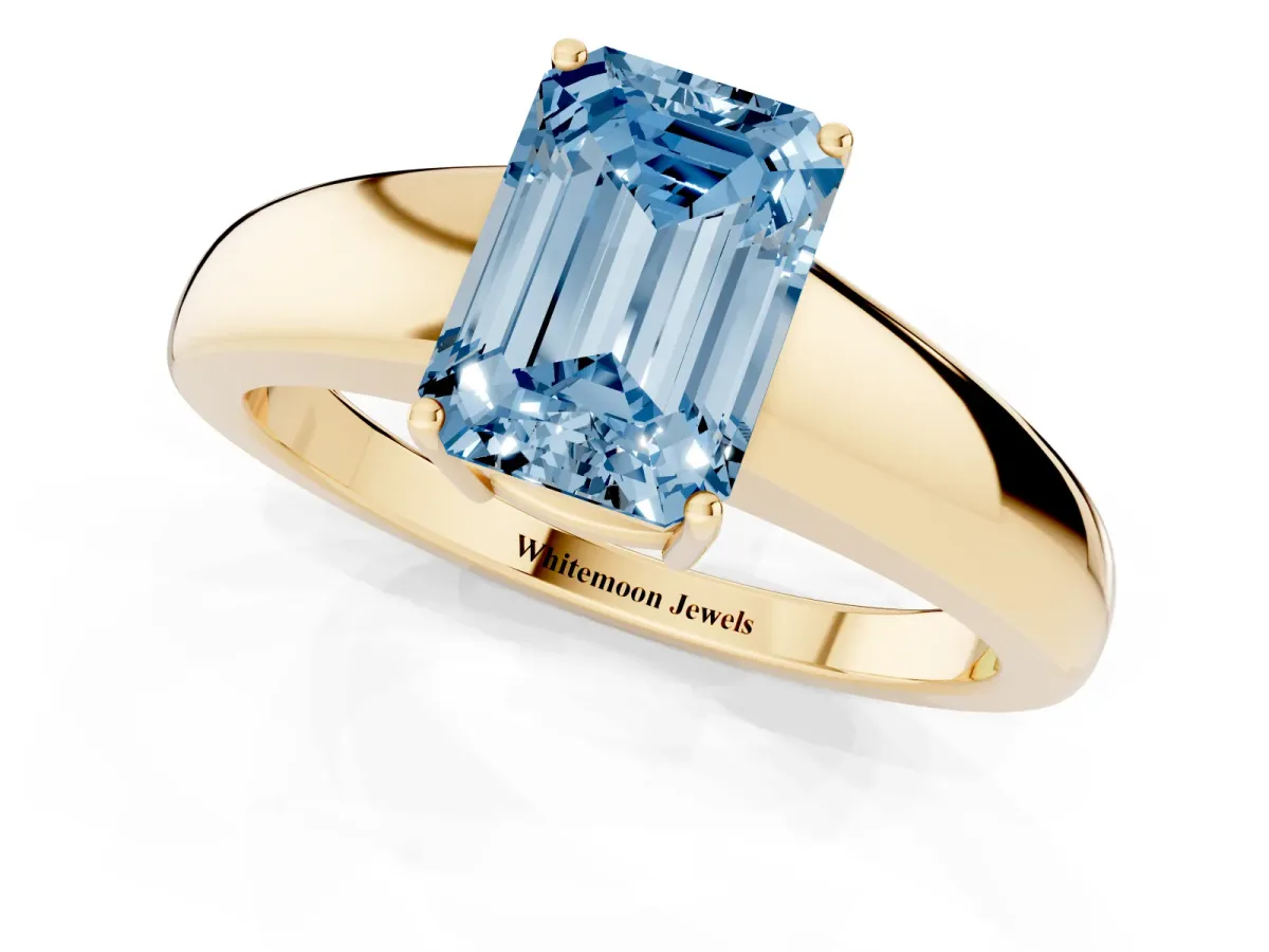 Fancy Blue Emerald Cut Solitaire Diamond Ring with Tapered Band and Four-Prong Setting Yellow gold