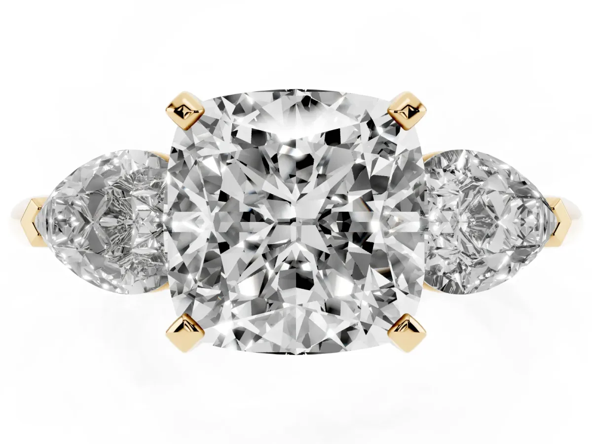 Three-Stone Cushion Cut Diamond Ring with Pear Side Stones and Four-Prong Setting Yellow gold