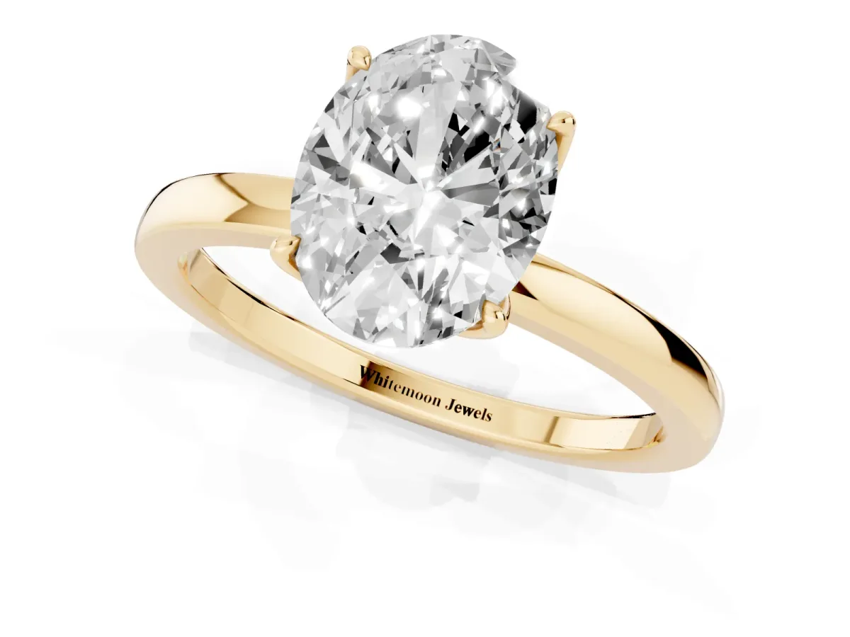 Oval Cut Diamond Solitaire Ring with Thin Band and Prong Setting Yellow gold