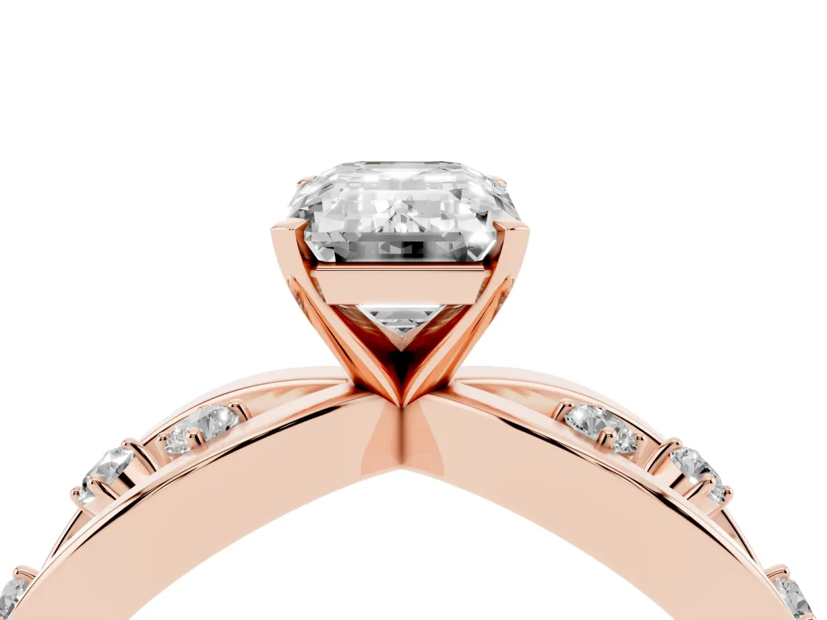 Emerald Cut Cut Solitaire Diamond with Side Stones on Criss-Cross Band and Four-Prong Setting Rose gold