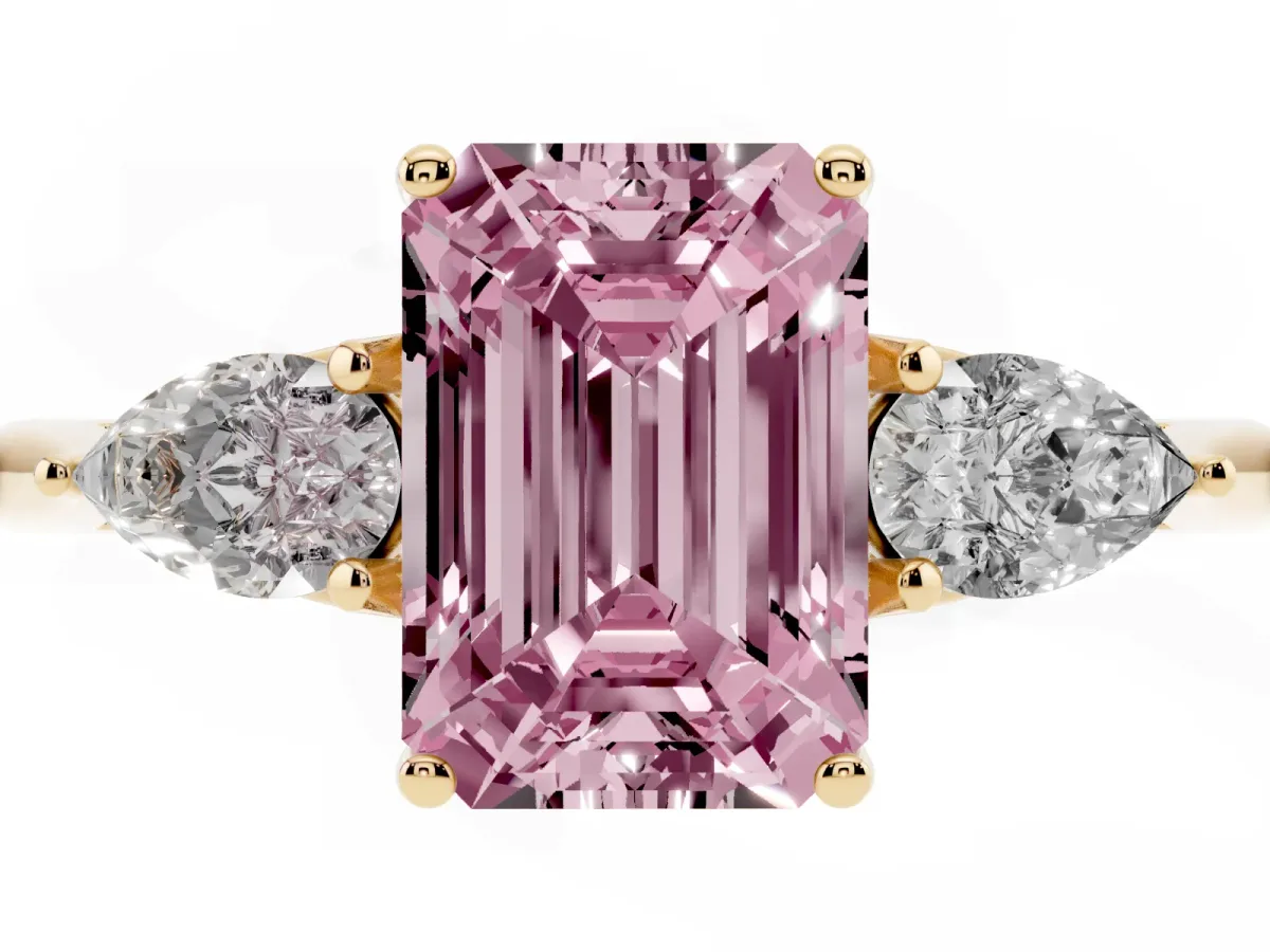 Fancy Pink Three-Stone Emerald Cut Diamond Ring with Pear Side Stones in Four-Prong Setting Yellow gold