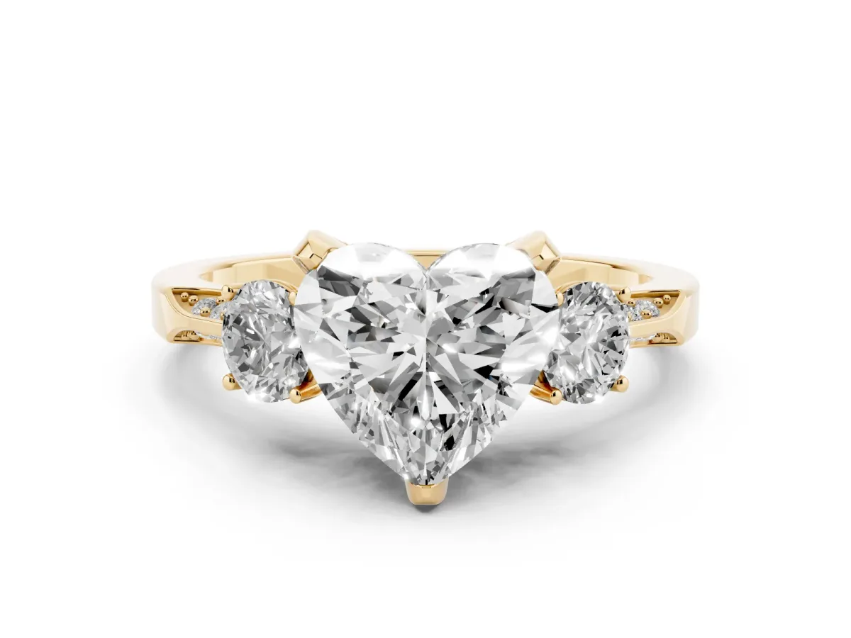 Heart Cut Brilliant Three-Stone Diamond Ring with Pavé Band and Four-Prong Setting Yellow gold