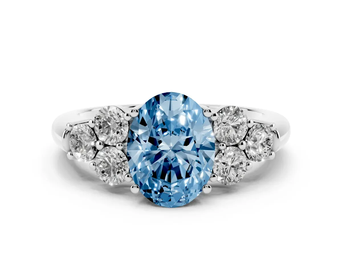 Fancy Blue Oval Cut Cut Diamond Cluster Ring with Round Accent Stones and Prong Setting on a Classic Band Silver