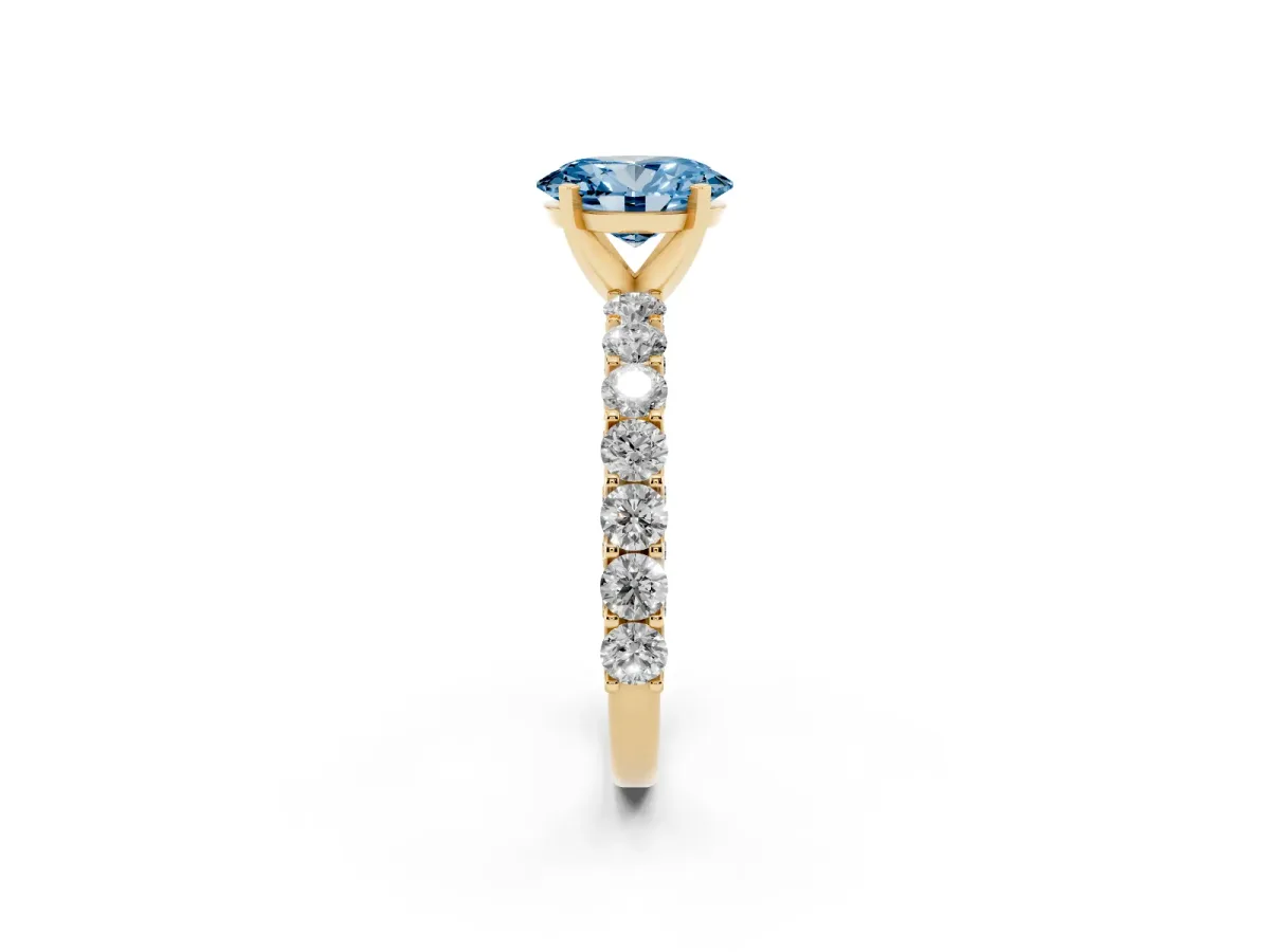 Fancy Blue Oval Cut Diamond Solitaire Ring with Shared Prong Pavé Band and Four-Prong Setting Yellow gold