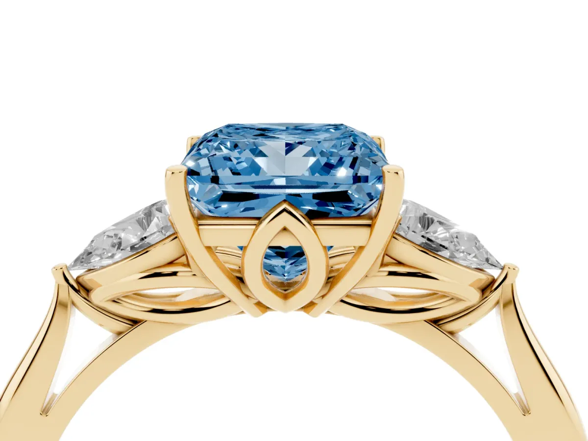 Fancy Blue Princess Cut Diamond Three-Stone Ring with Pear Side Stones and Prong Setting Yellow gold