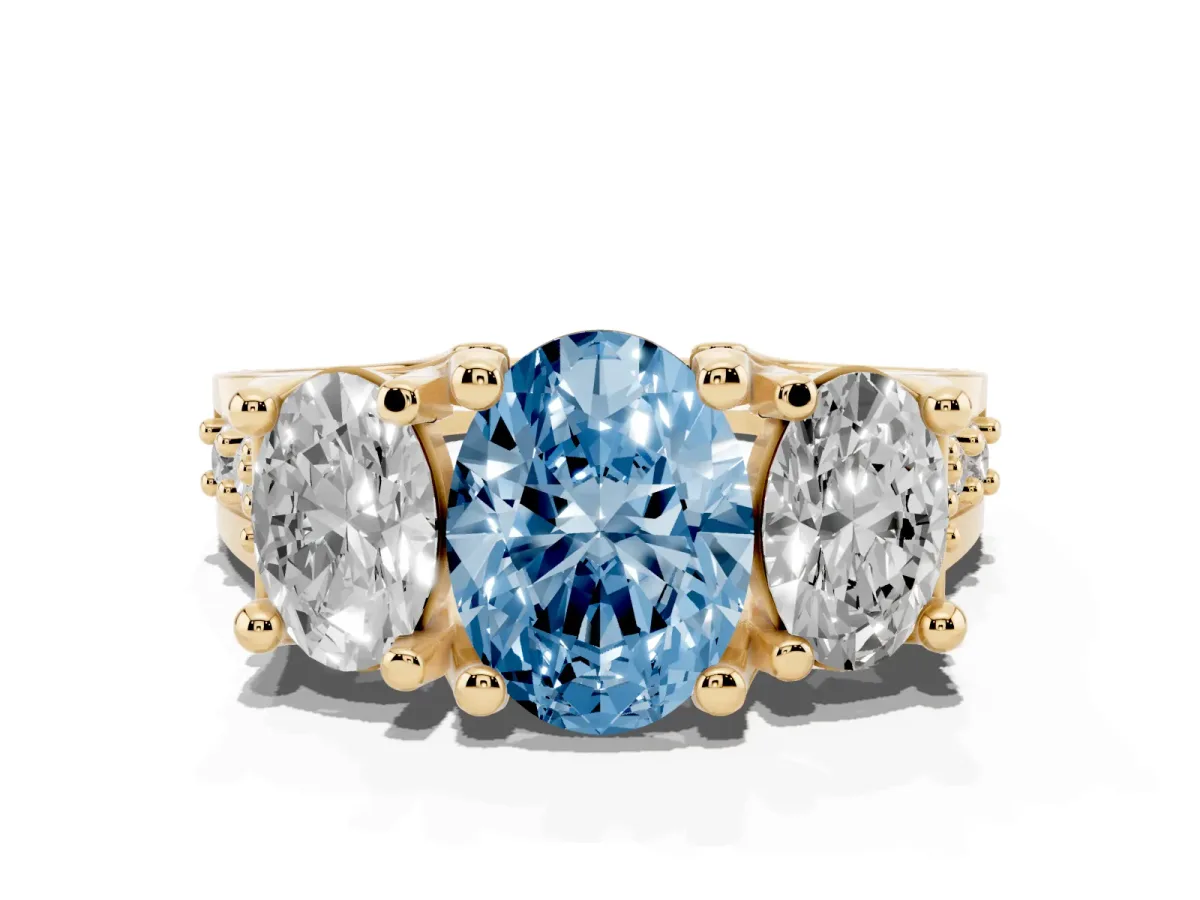 Fancy Blue Oval Cut Diamond Three-Stone Ring with Channel Set Band and Four-Prong Setting Yellow gold