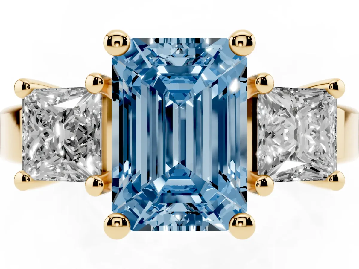 Fancy Blue Three-Stone Emerald Cut Cut Solitaire Ring with Prong Setting Yellow gold