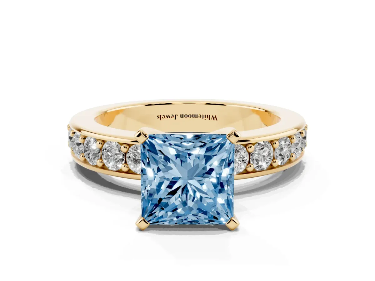 Fancy Blue Princess Cut Diamond Engagement Ring with Channel Set Round Band and Prong Setting Yellow gold
