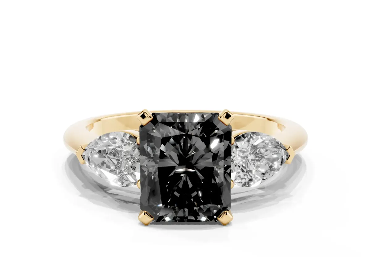 Fancy Black Three-Stone Radiant Cut Diamond Ring with Pear Side Stones and Four-Prong Setting Yellow gold