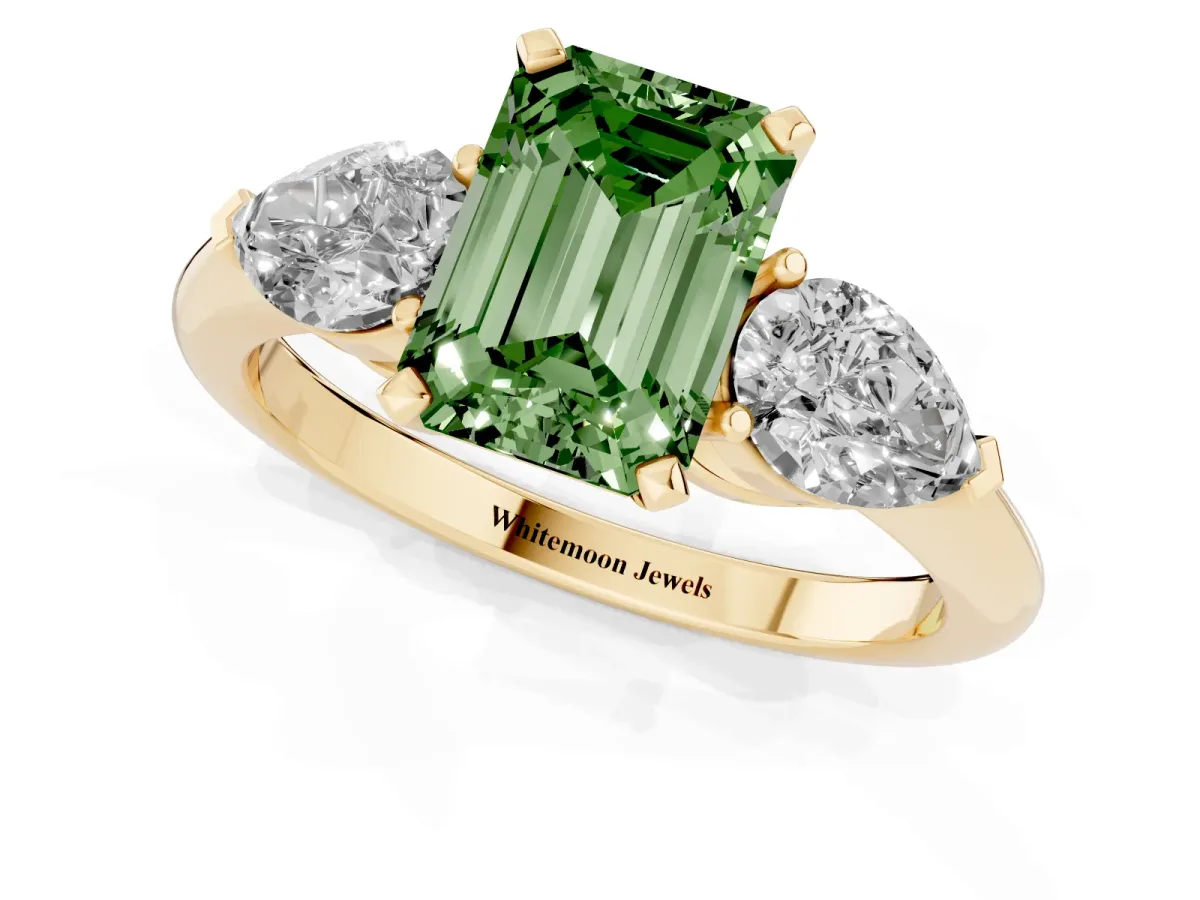 Fancy Green Three-Stone Emerald Cut Diamond Ring with Pear Side Stones and Four-Prong Setting Yellow gold