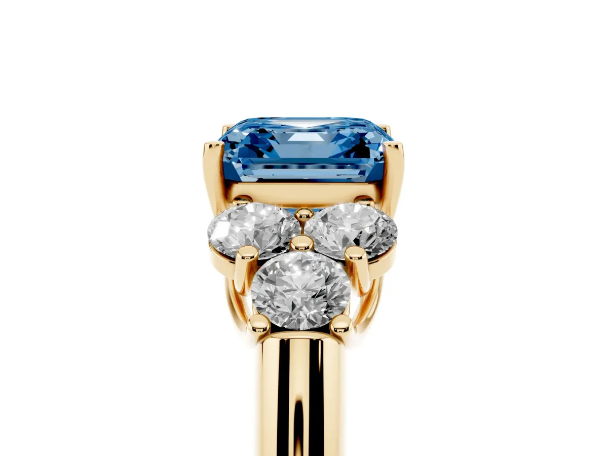 Fancy Blue Asscher Cut Cut Diamond Cluster Ring with Round Accent Stones and Prong Setting on a Classic Band Yellow gold