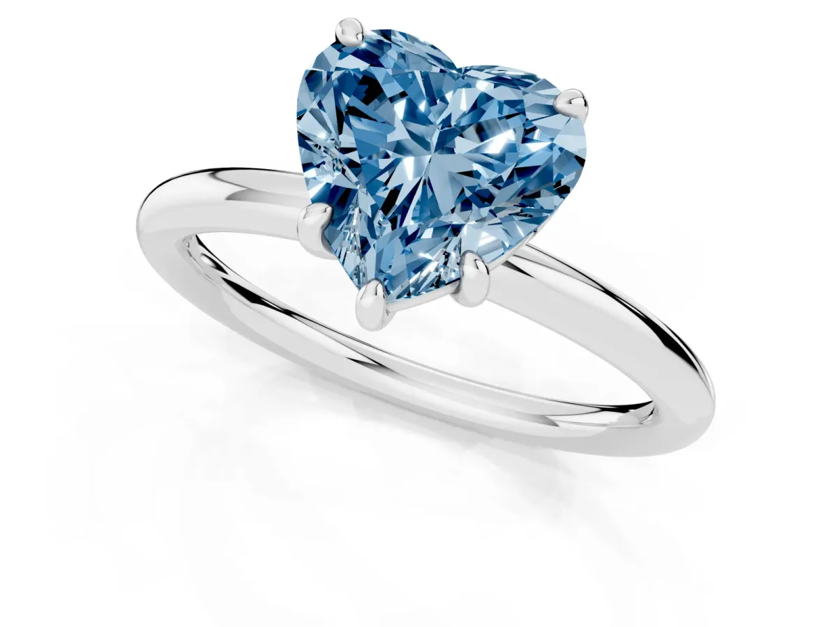 Fancy Blue Heart Cut Solitaire Diamond Ring with Four-Prong Setting on a Plain Band Platinum