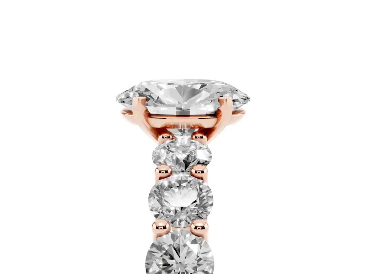 Oval Cut Diamond Prong Setting with Side Stones on a Pave Band Rose gold