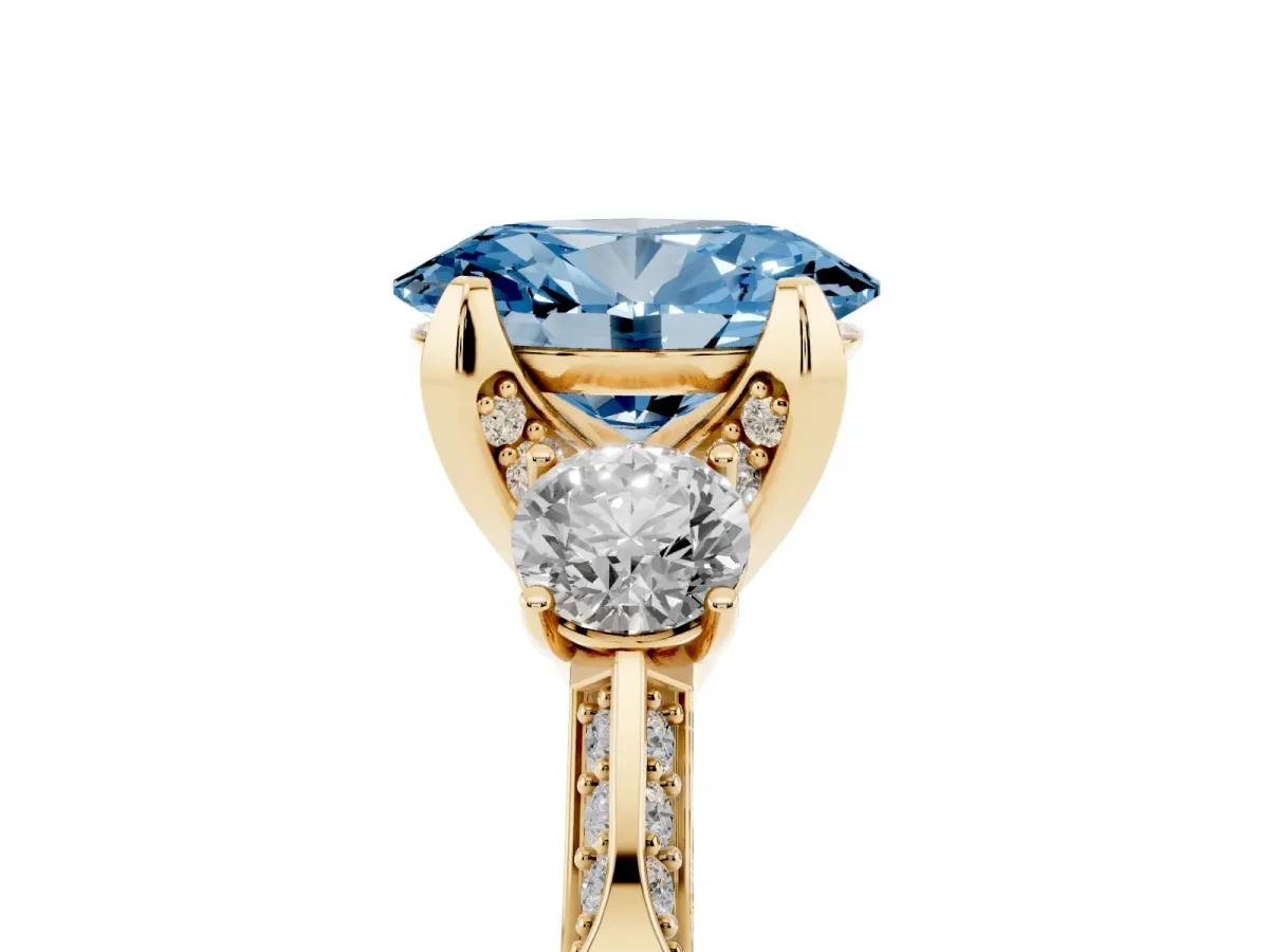 Fancy Blue Oval Cut Brilliant Three-Stone Diamond Ring with Pavé Band and Four-Prong Setting Yellow gold