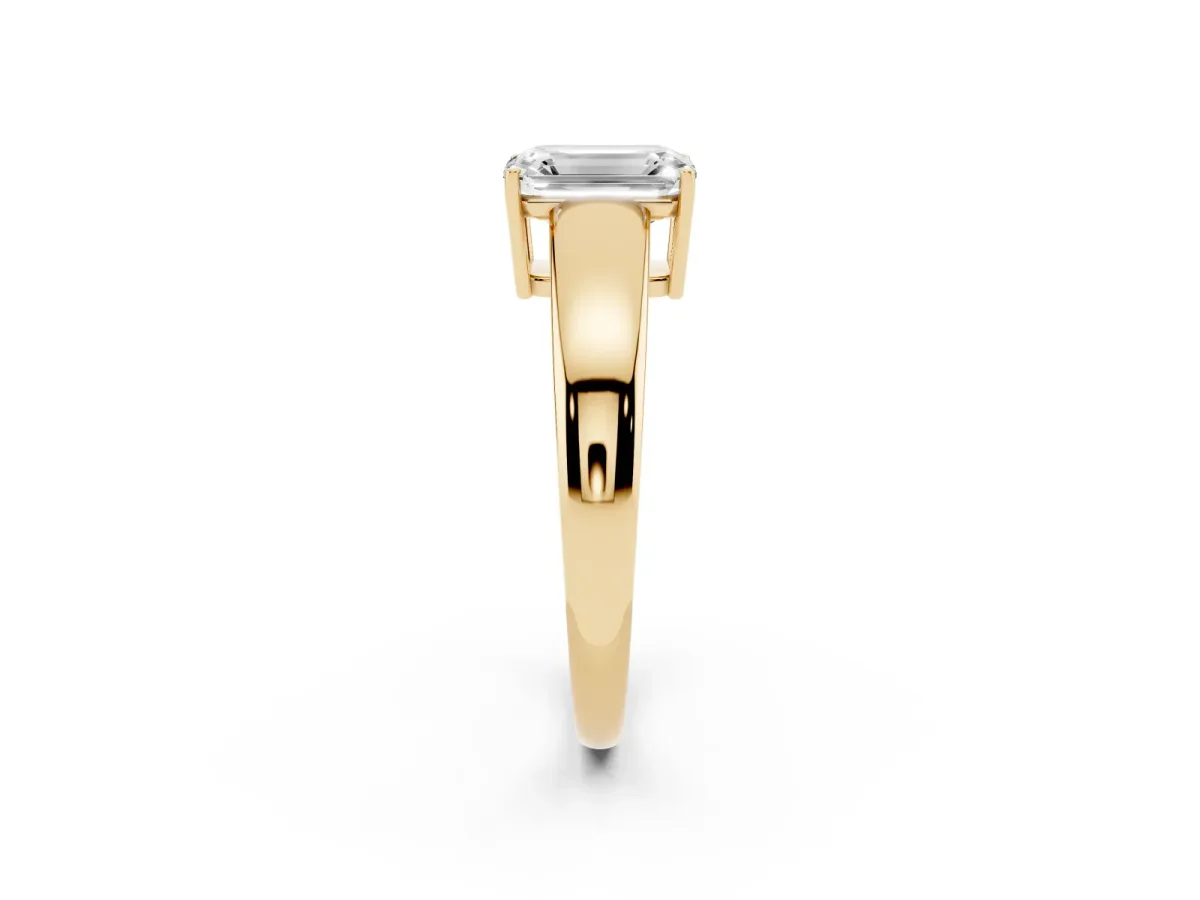 Emerald Cut Solitaire Diamond Ring with Tapered Band and Four-Prong Setting Yellow gold