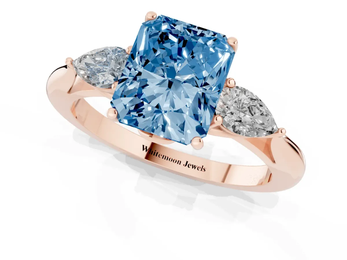 Fancy Blue Three-Stone Radiant Cut Diamond Ring with Pear Side Stones in Four-Prong Setting Rose gold