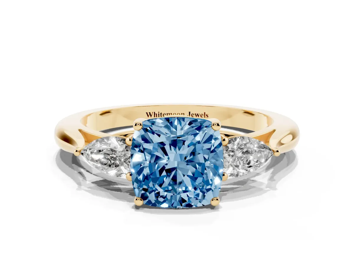 Fancy Blue Cushion Cut Diamond Three-Stone Ring with Pear Side Stones and Prong Setting Yellow gold