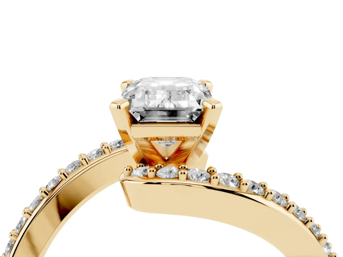Emerald Cut Solitaire Twist Band with Pave Set Diamonds and Four-Prong Setting Yellow gold