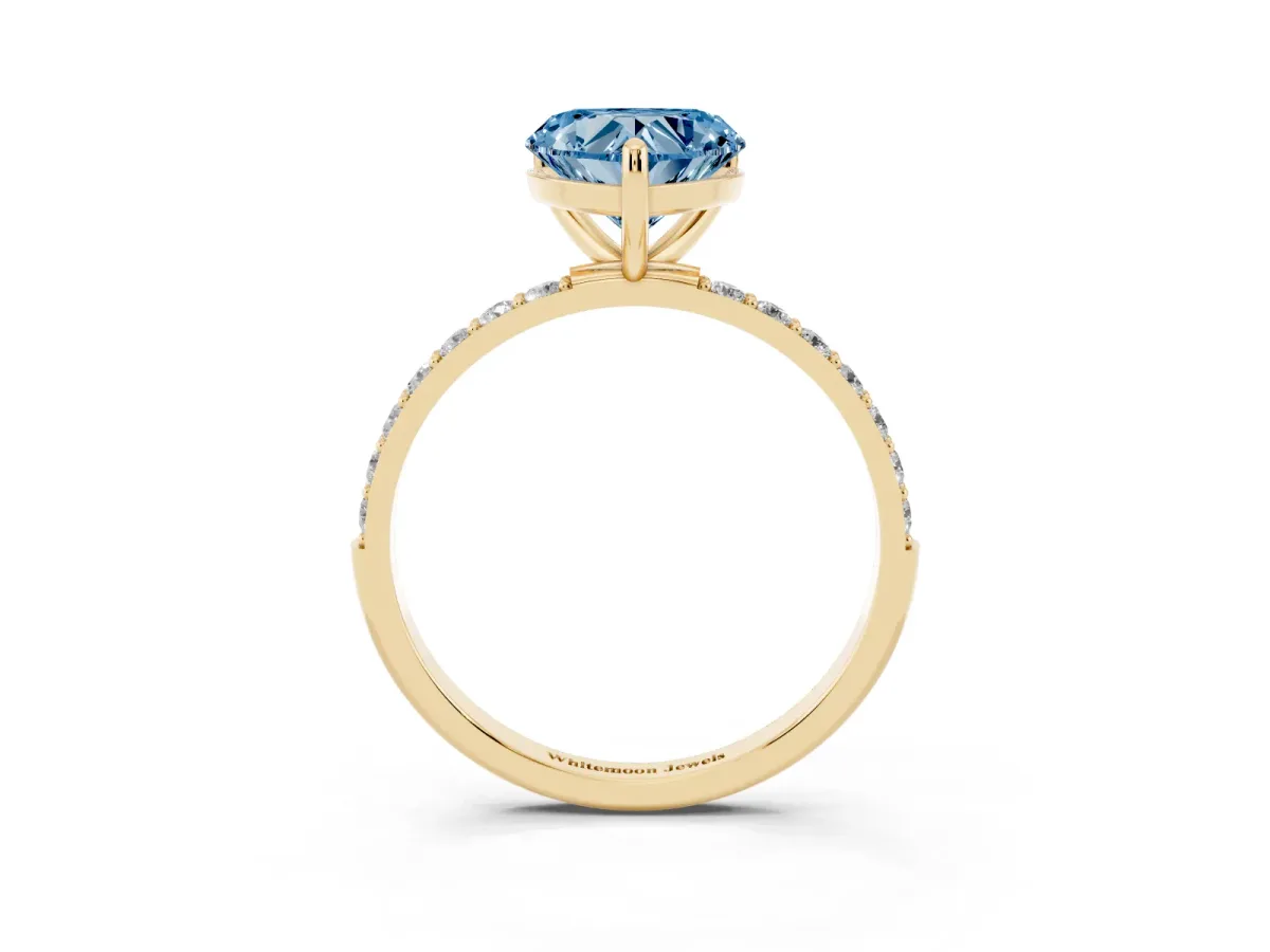 Fancy Blue Heart Cut Diamond Solitaire Ring with Round Pavé Band and Prong Setting Yellow gold