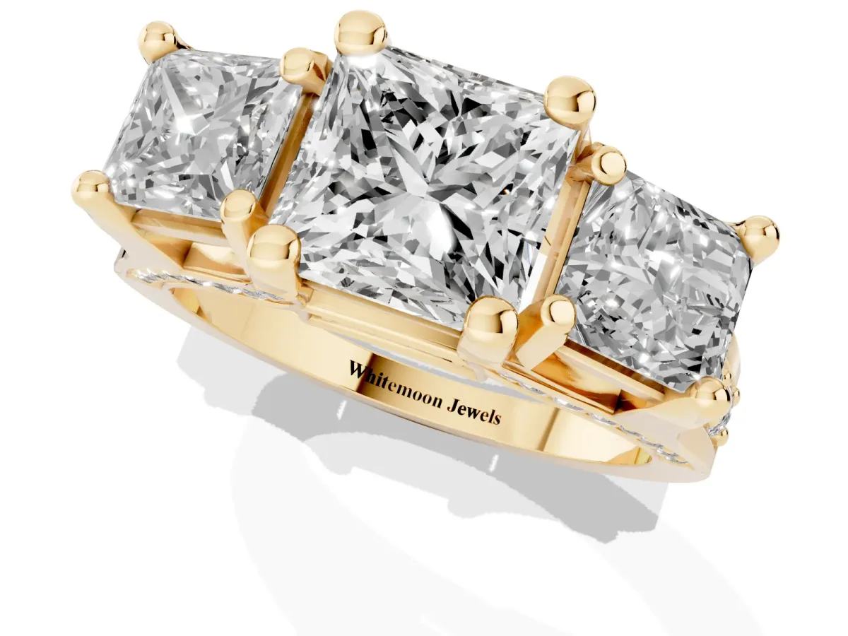 Princess Cut Diamond Three-Stone Ring with Channel Set Band and Four-Prong Setting Yellow gold