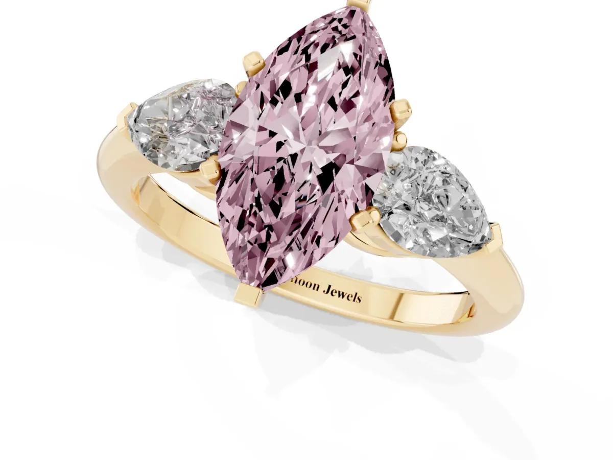 Fancy Pink Three-Stone Marquise Cut Diamond Ring with Pear Side Stones and Four-Prong Setting Yellow gold