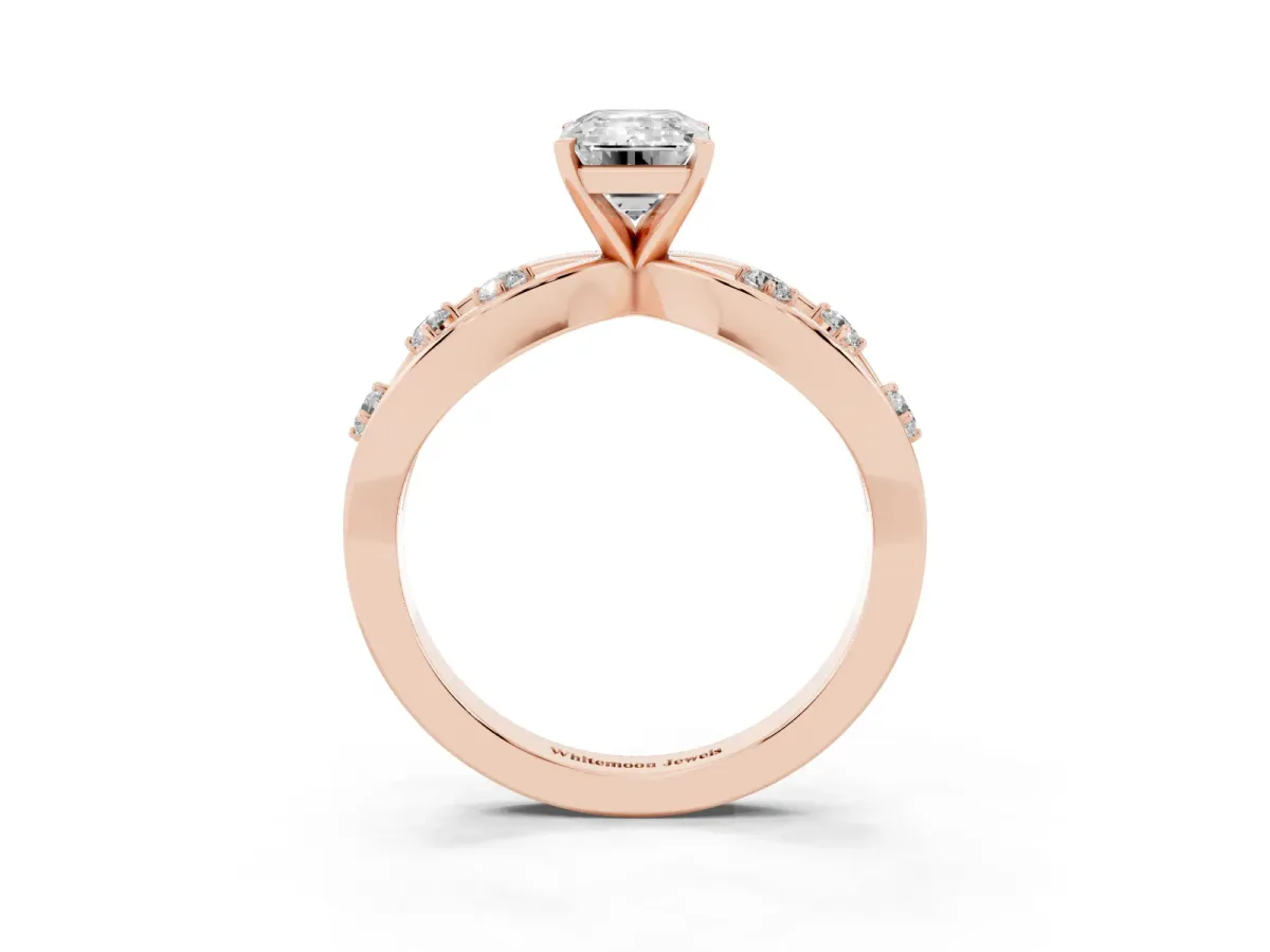 Emerald Cut Cut Solitaire Diamond with Side Stones on Criss-Cross Band and Four-Prong Setting Rose gold