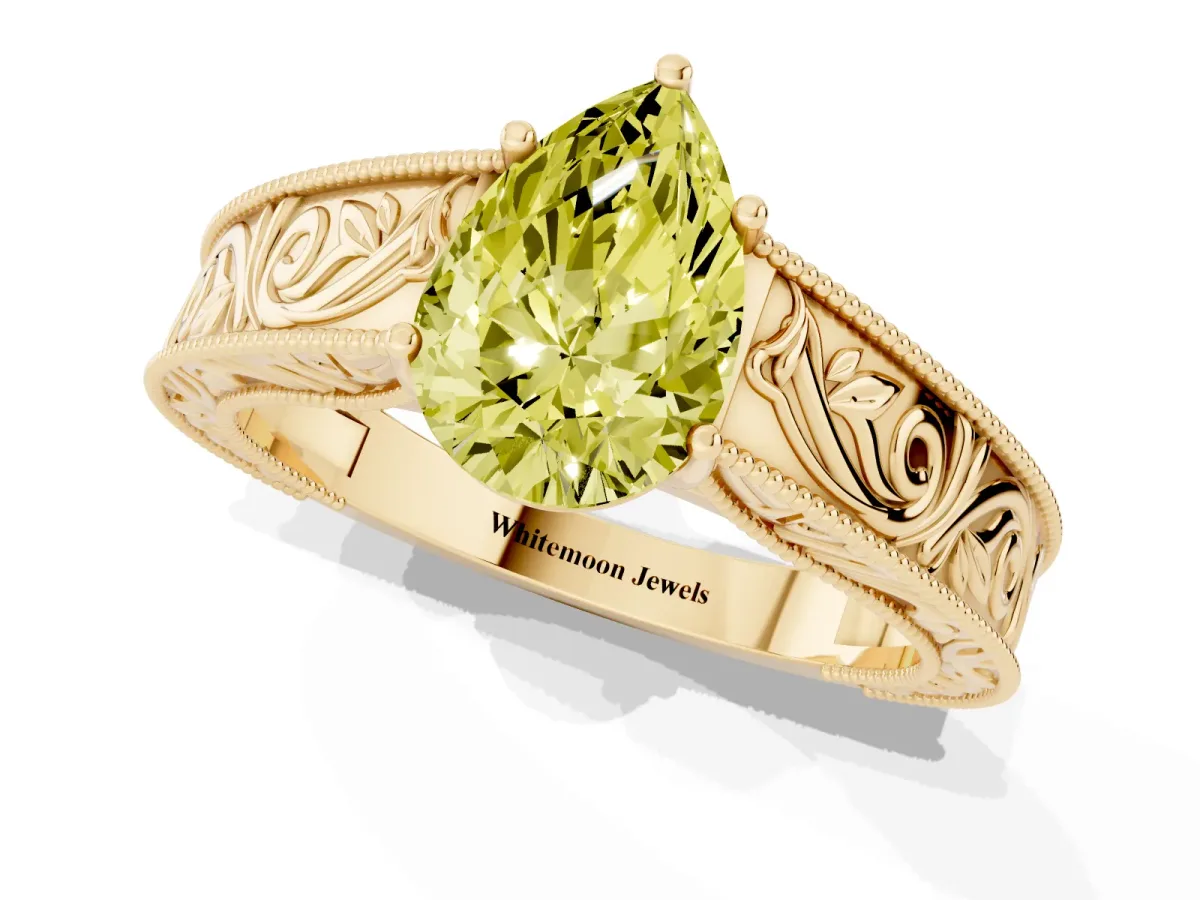 Fancy Yellow Pear Cut Diamond Solitaire Ring with Engraved Band and Four-Prong Setting Yellow gold