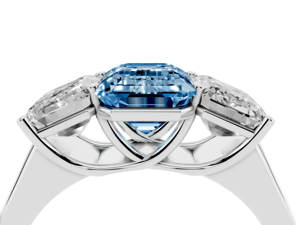 Fancy Blue Emerald Cut Three-Stone Diamond Ring with Prong Setting on a Classic Band Silver