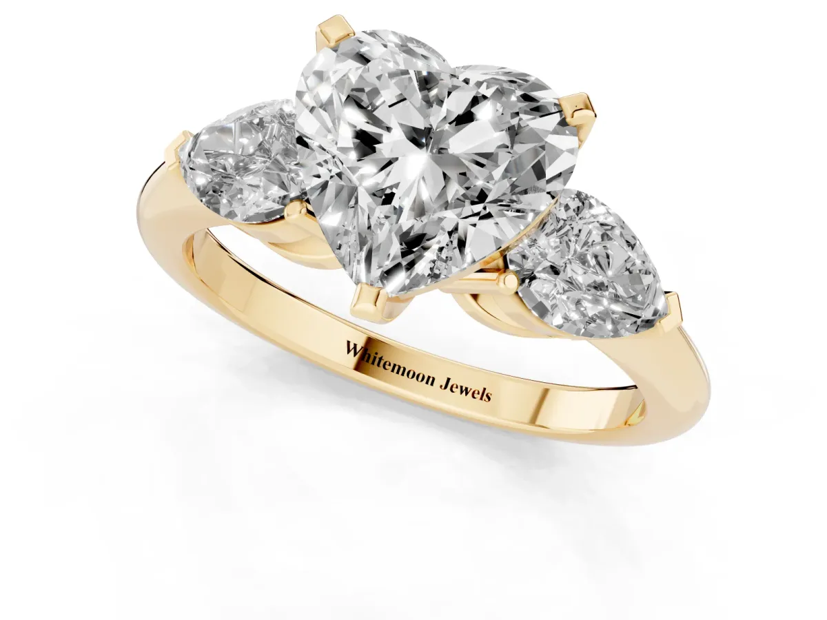 Three-Stone Heart Cut Diamond Ring with Pear Side Stones and Four-Prong Setting Yellow gold