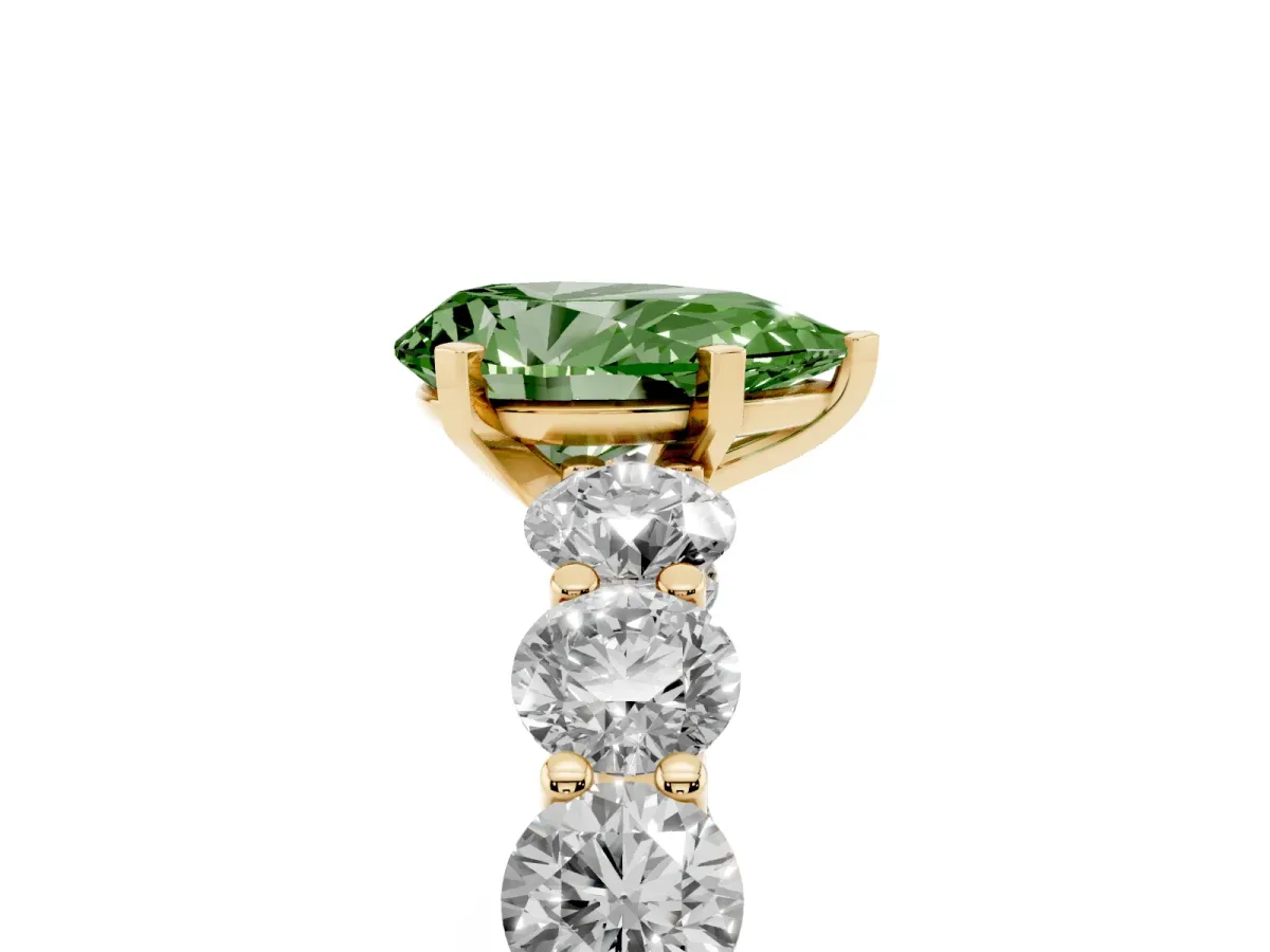 Fancy Green Pear Cut Diamond Prong Setting with Side Stones on a Pave Band Yellow gold