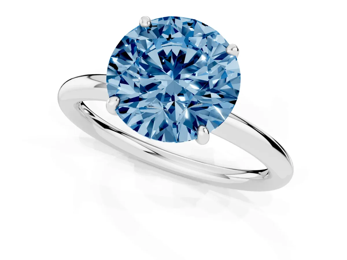 Fancy Blue Round Cut Solitaire Diamond Ring with Four-Prong Setting on a Plain Band Silver