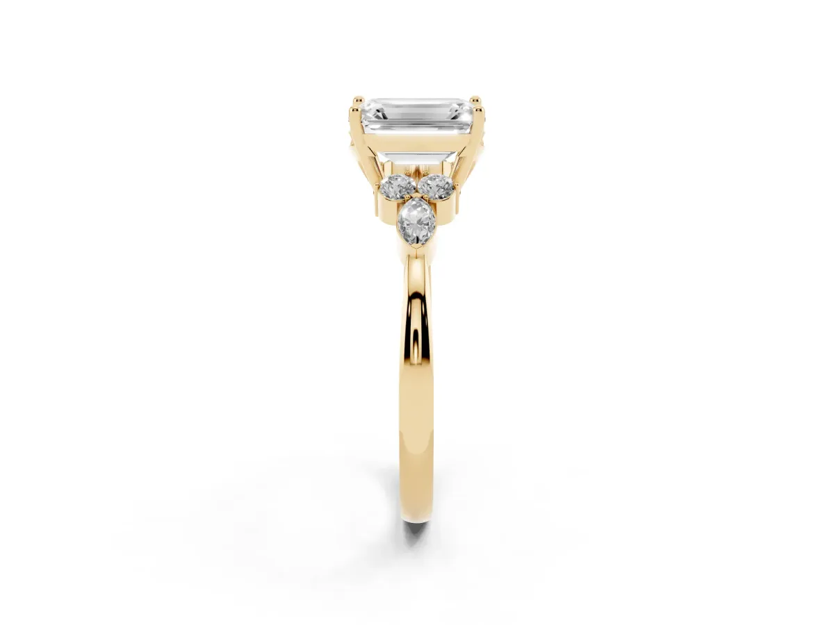 Emerald Cut Brilliant Diamond Solitaire Ring with Pear Side Stones and Four-Prong Setting Yellow gold