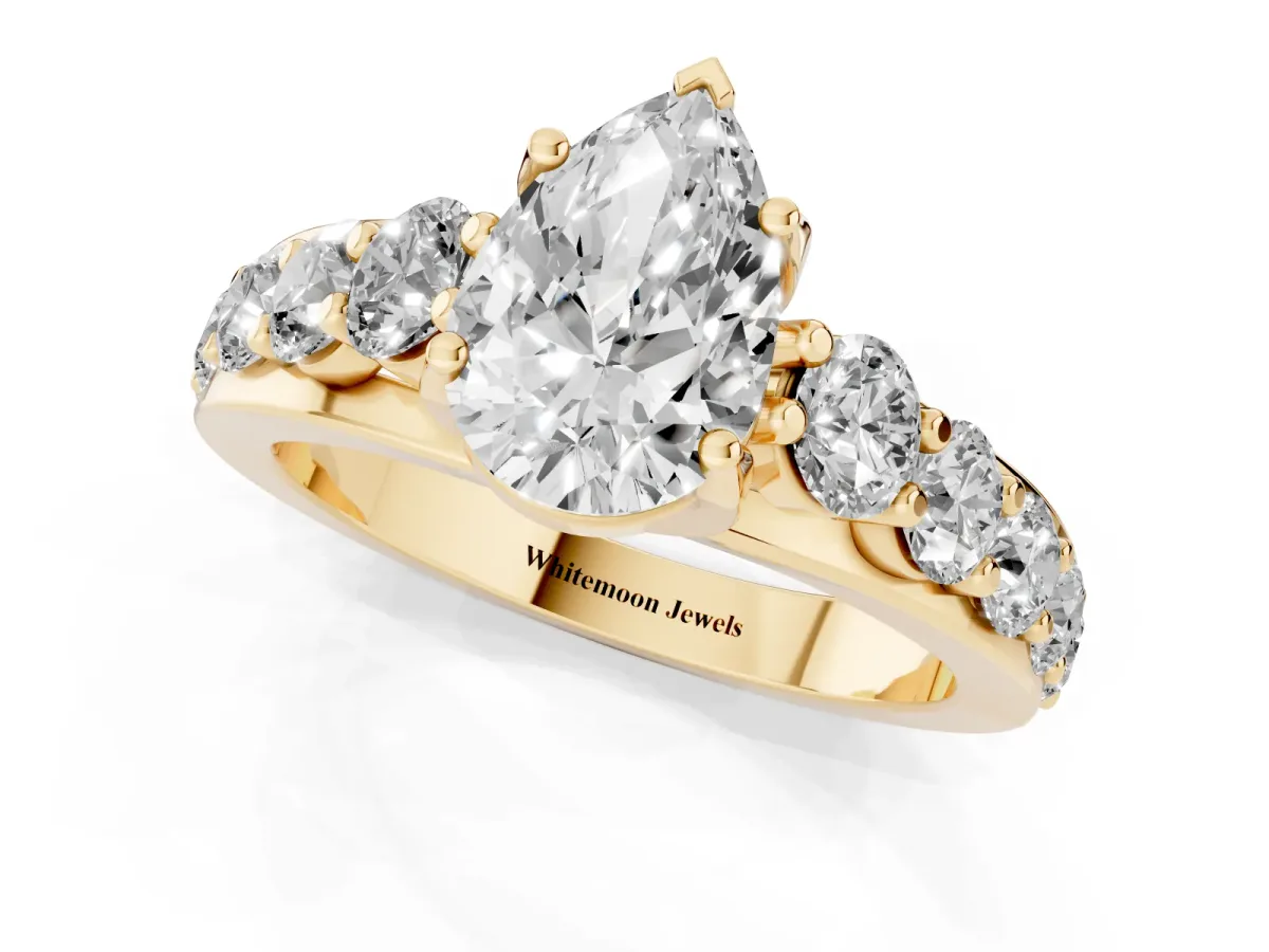 Pear Cut Diamond Engagement Ring with Pavé Band and Four-Prong Setting Yellow gold