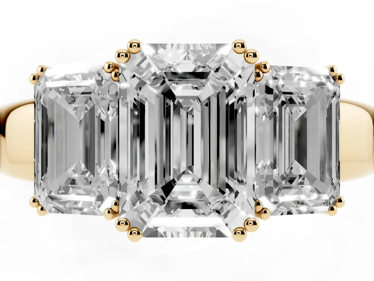 Three-Stone Emerald Cut Cut Diamond Ring with Channel Set Band and Four-Prong Setting Yellow gold