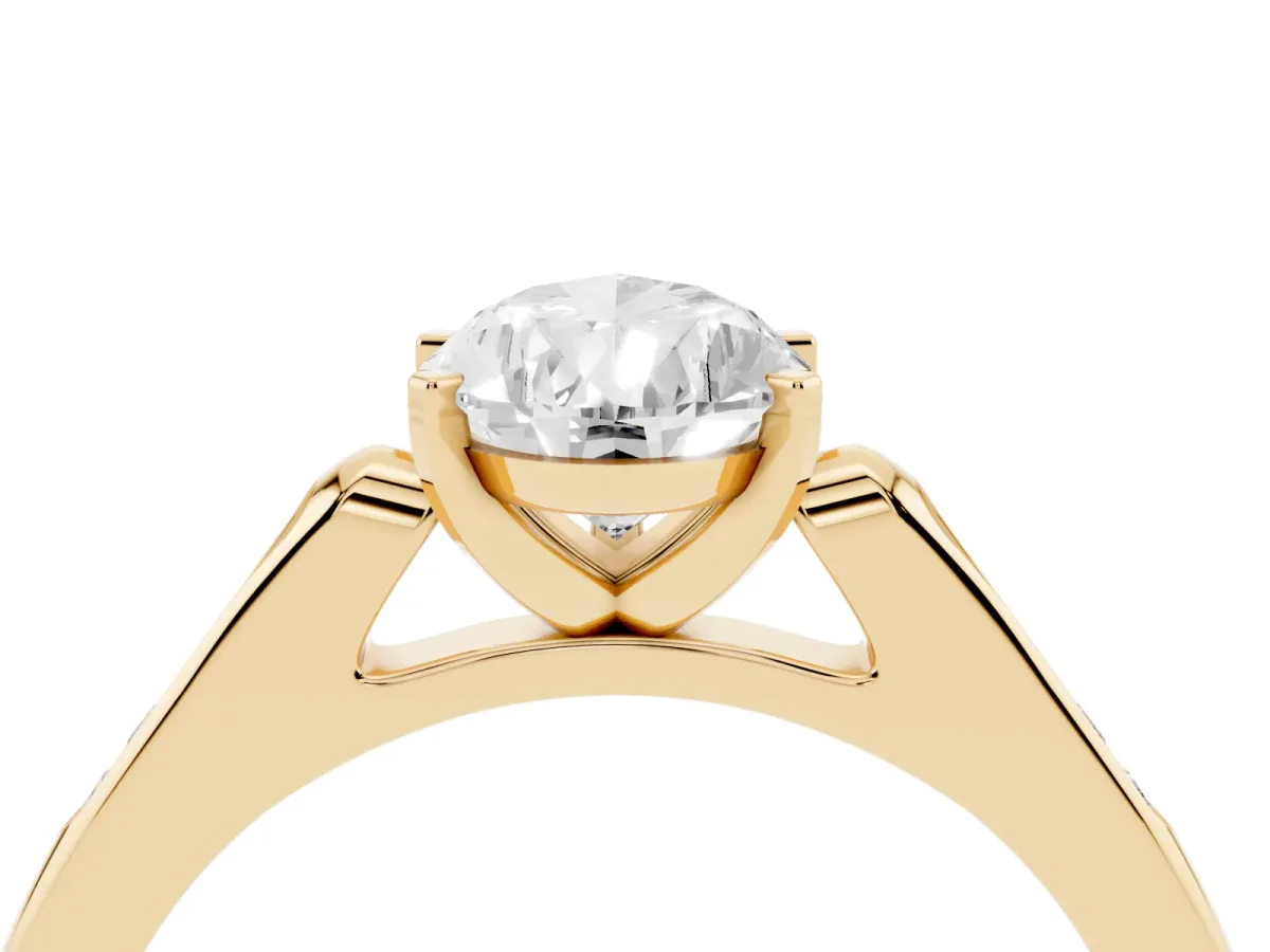 Pear Cut Diamond Solitaire Ring with Channel Set Round Band and Prong Setting Yellow gold