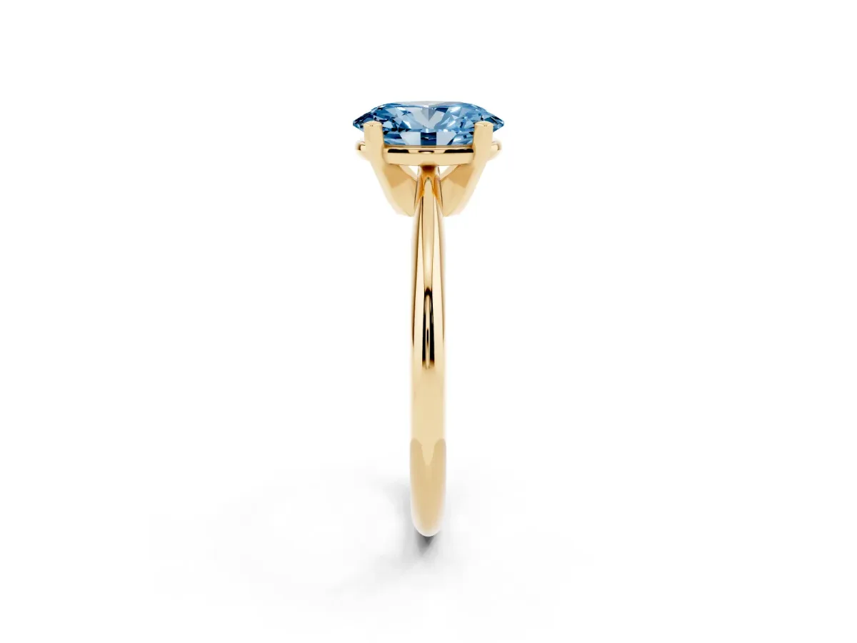 Fancy Blue Oval Cut Cut Solitaire Ring with Four-Prong Setting on a Classic Band Yellow gold