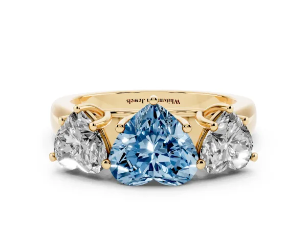 Fancy Blue Heart Cut Three-Stone Diamond Ring with Prong Setting on a Classic Band Yellow gold