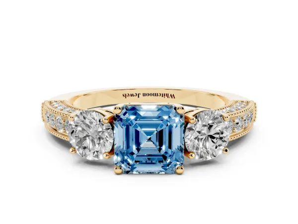 Fancy Blue Asscher Cut Three-Stone Diamond Ring with Pavé Band and Four-Prong Setting Yellow gold