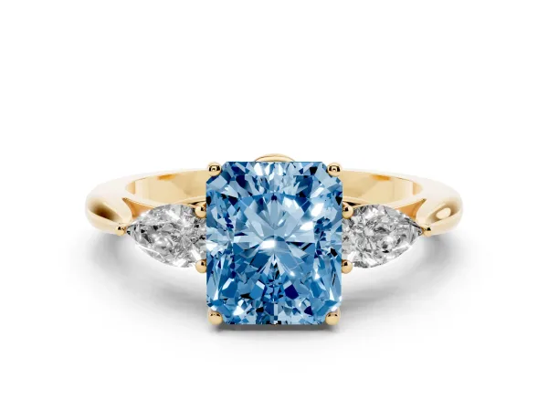 Fancy Blue Three-Stone Radiant Cut Diamond Ring with Pear Side Stones in Four-Prong Setting Yellow gold