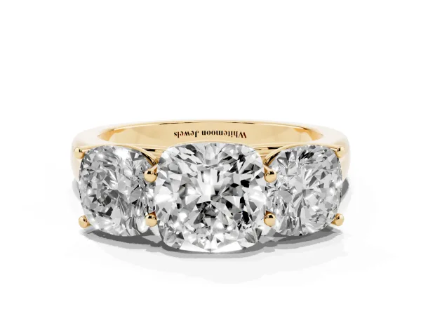 Cushion Cut Three-Stone Diamond Ring with Prong Setting on a Classic Band Yellow gold
