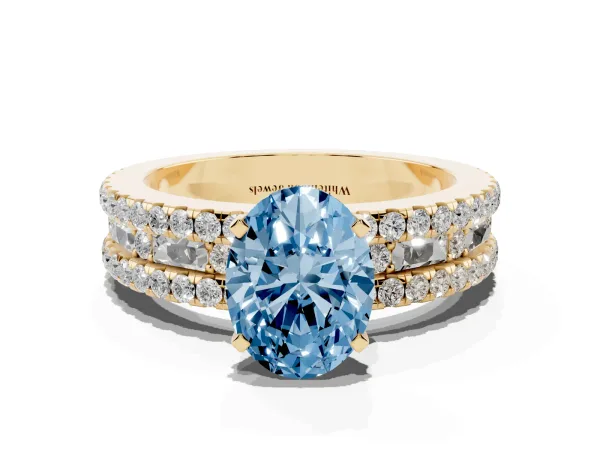 Fancy Blue Oval Cut Diamond Solitaire Ring with Pavé and Channel Set Band Yellow gold