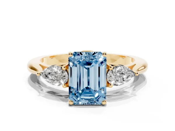 Fancy Blue Three-Stone Emerald Cut Diamond Ring with Pear Side Stones in Four-Prong Setting Yellow gold